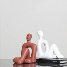 Red and White Sitting Human Decor